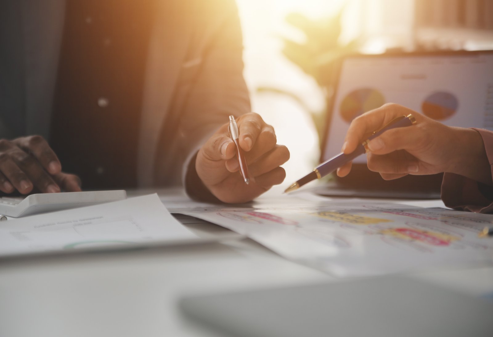 close up of business team analyzing income charts and graphs wit